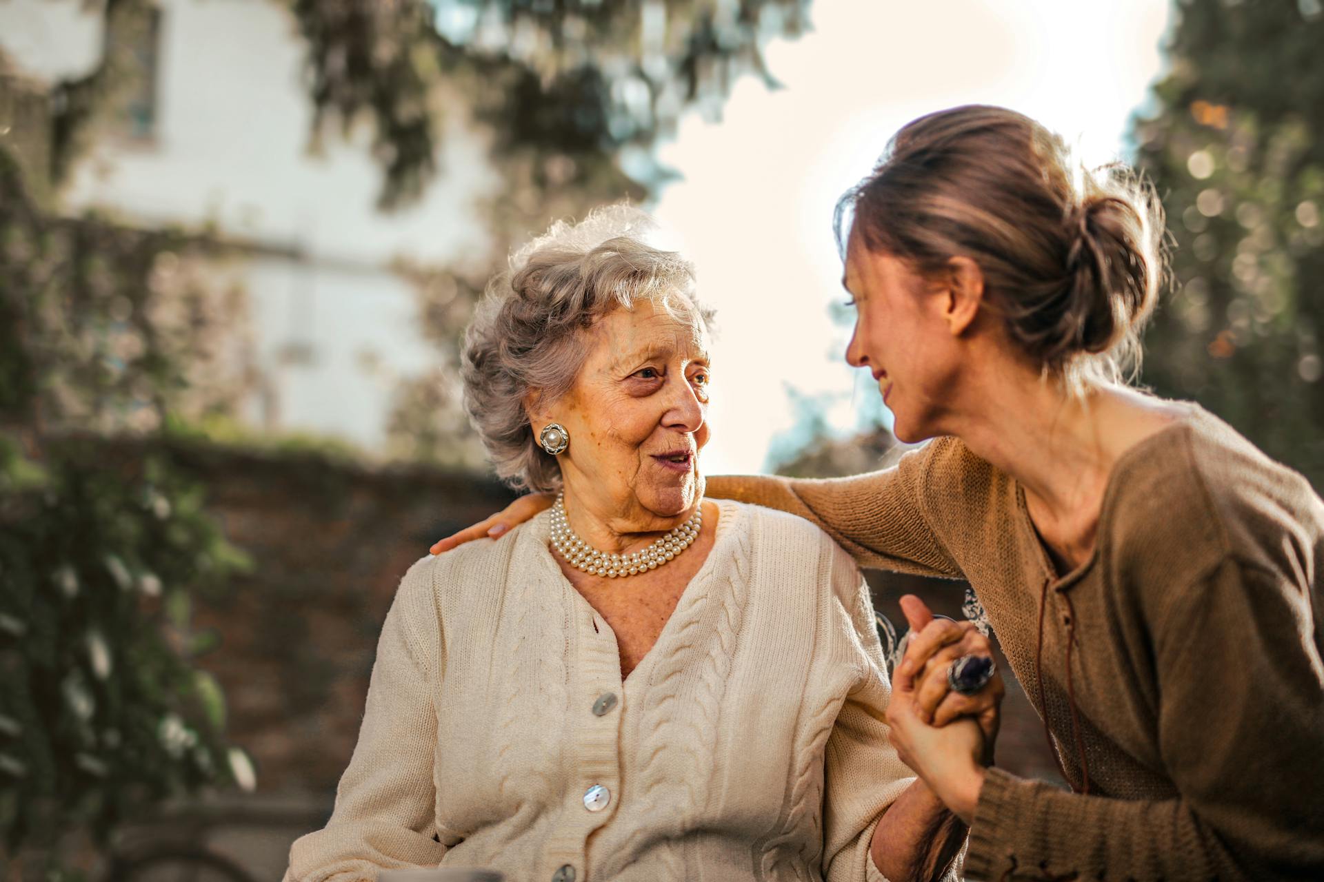 A young woman talking to an elderly woman